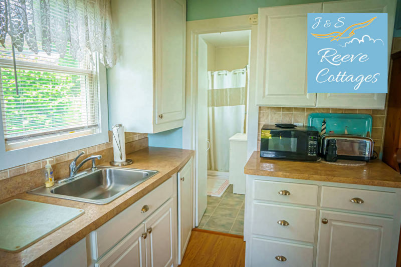 Cozy Waterfront Cottage 4 looking through main entrance showing kitchen and bathroom