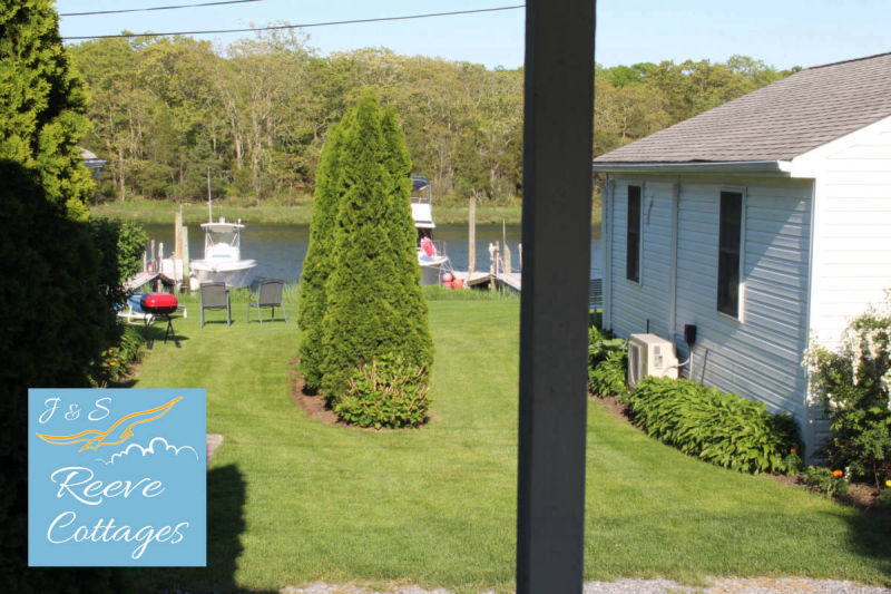 Cozy Waterfront Cottage 4 Screened-In Porch late in the day viewing the water of Reeves Creek