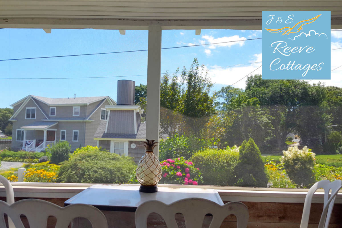 Cozy Waterfront Cottage 5 Screened-In Porch on a summer day viewing the property gardens