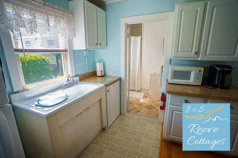 Cozy Waterfront Cottage 6 looking through main entrance showing kitchen and bathroom