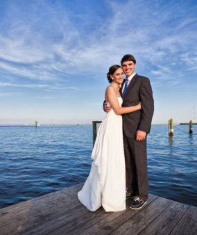 Wedding guest accommodations on waterfront vacation rentals showing bride and groom on one of our docks